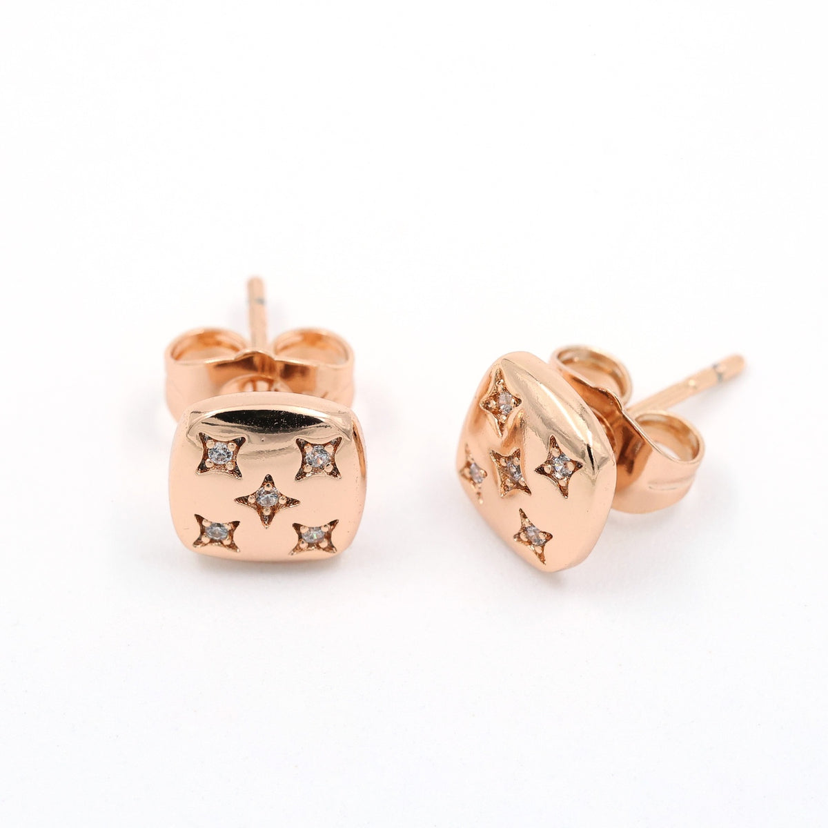 "Rose gold-plated stud earrings with star-shaped cubic zirconia detailing."