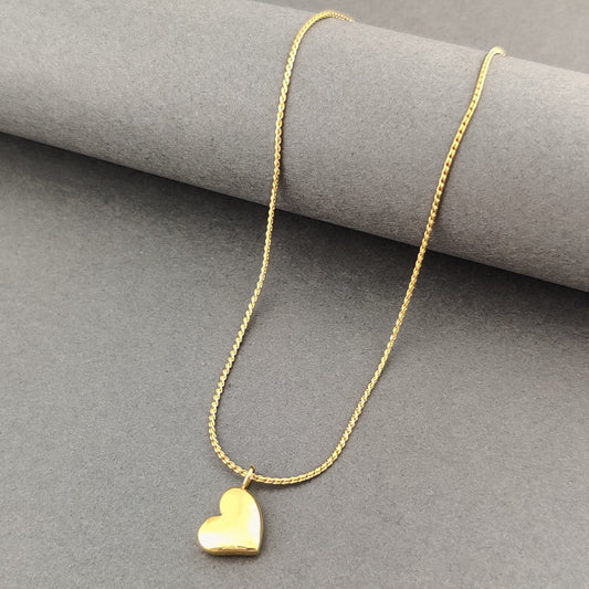 "Gold heart pendant necklace on a delicate chain, romantic jewelry accessory, perfect for gifts and special occasions, displayed on a neutral gray background."