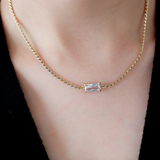 "Minimal gold chain necklace with baguette-cut crystal pendant, modern fine jewellery"